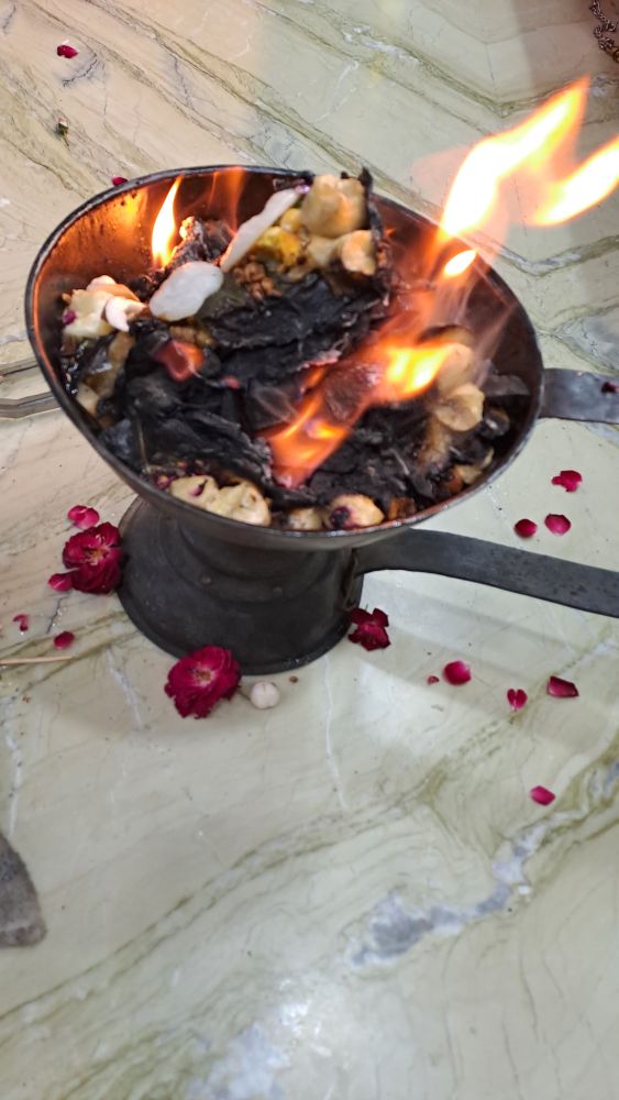A sacred fire offering with flowers